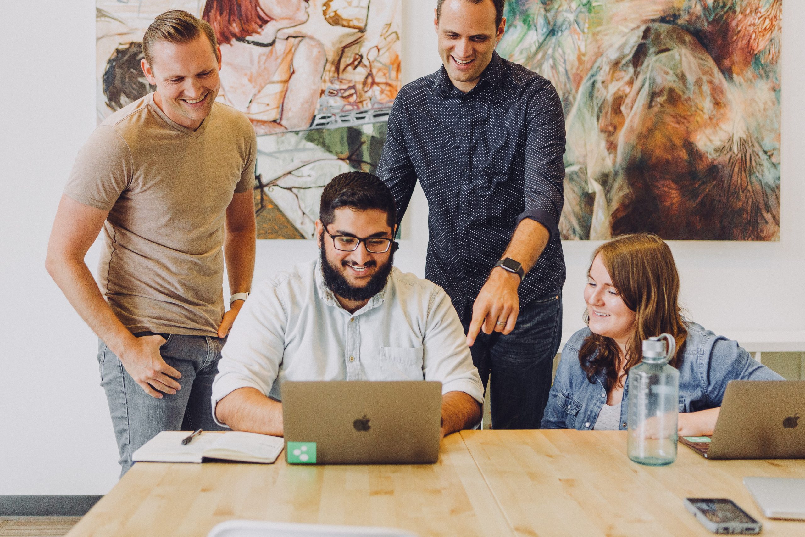 group of people looking at a laptop